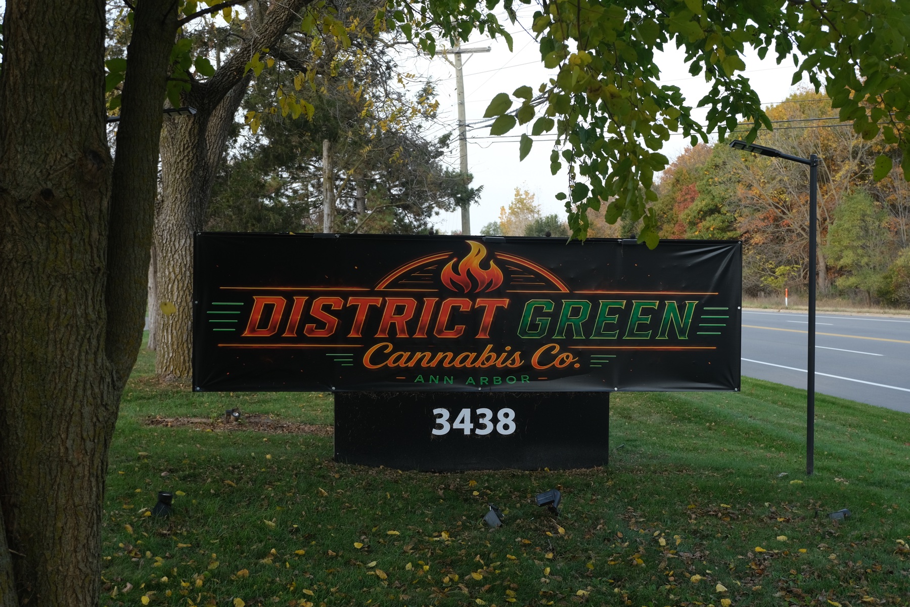 District Green roadside sign and address number 3438